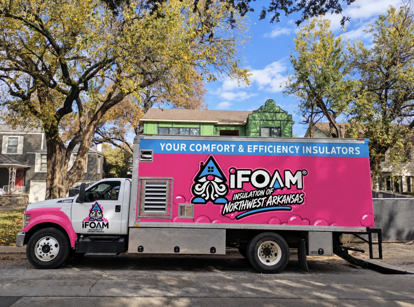 The rear doors of an iFOAM spray rig open on a driveway, hose reels and proportioner in view